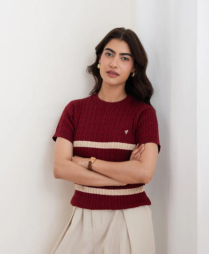 Red fitted knit top with crew neck and short sleeves, cream striped bands, ribbed texture