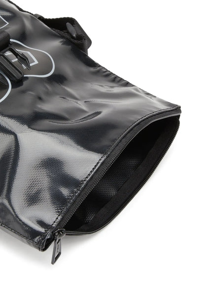 Black Diesel bag corner detail with zip top and stitched edge, close-up