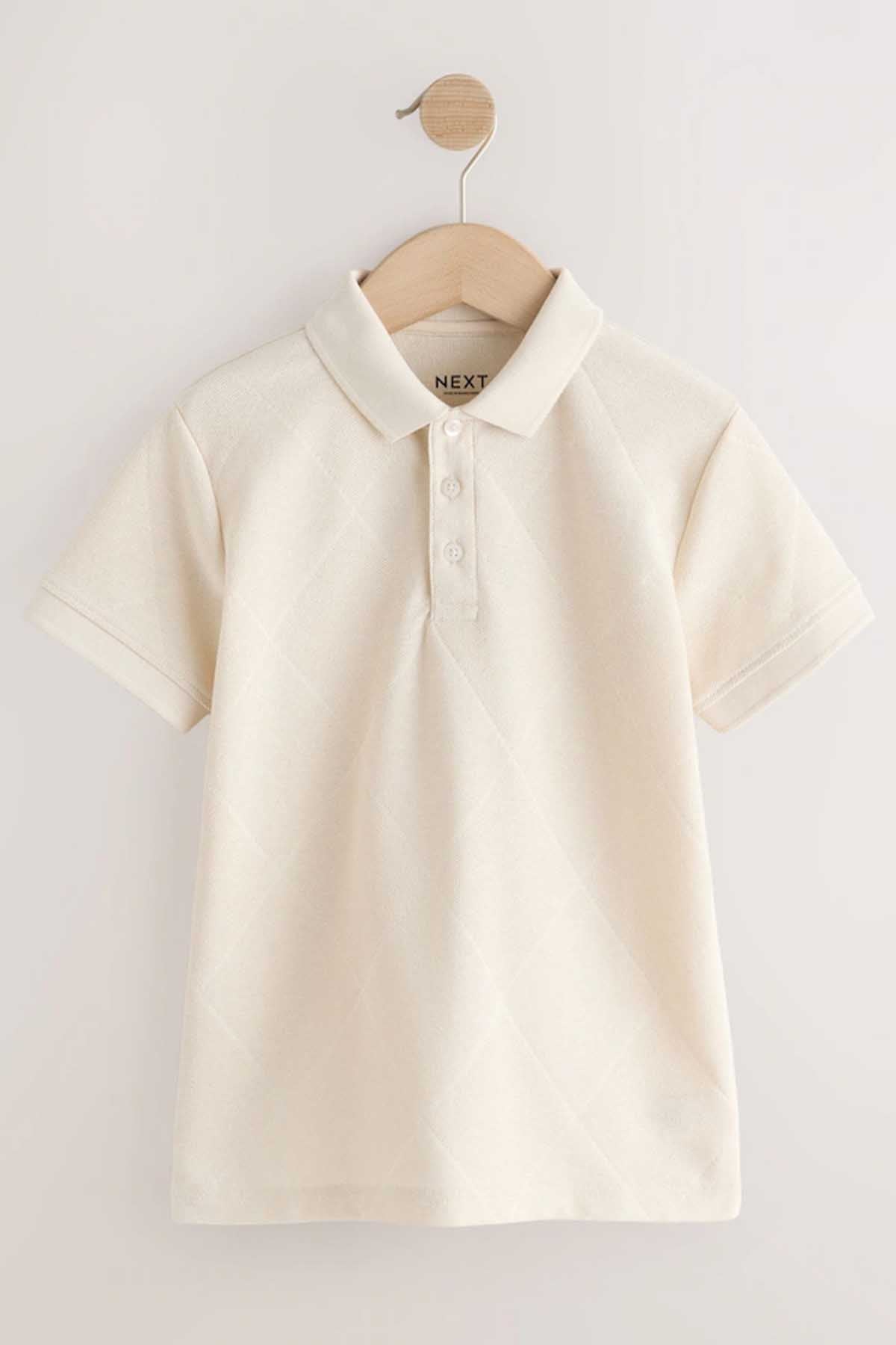 NEXT cream polo shirt on wooden hanger, front view with logo at collar