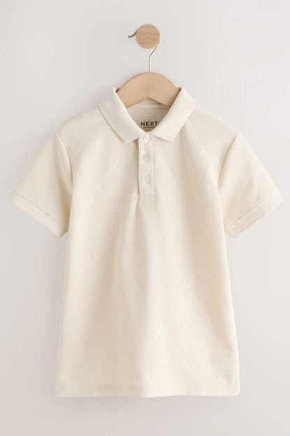 NEXT cream polo shirt on wooden hanger, front view with logo at collar