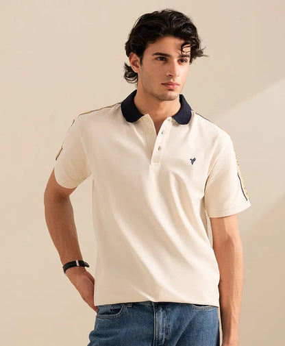 Fitted off-white polo shirt with navy collar, button placket, and small chest logo.