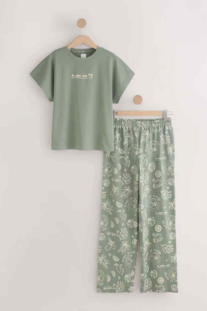 Sage green T-shirt and pajama trousers set hanging on a display