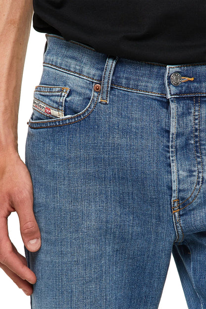 Men's blue jeans with button waistband, stitched front pockets, and coin pocket