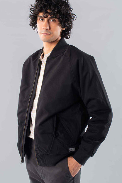 Black jacket with zip front, angled pockets, and ribbed cuffs