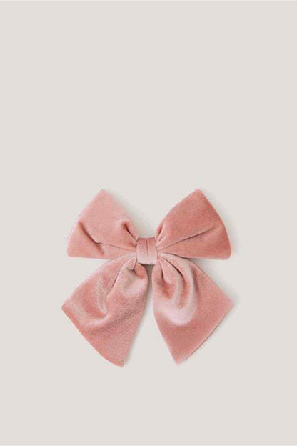 Pink fabric bow hair accessory with pleated loops and tied center knot