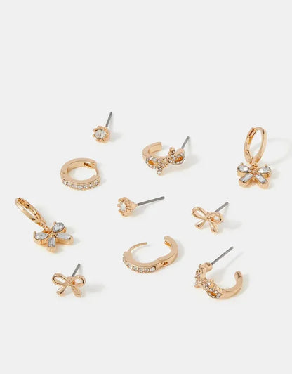 Gold-tone mixed earrings set with crystal bows, hoops, and star flower studs