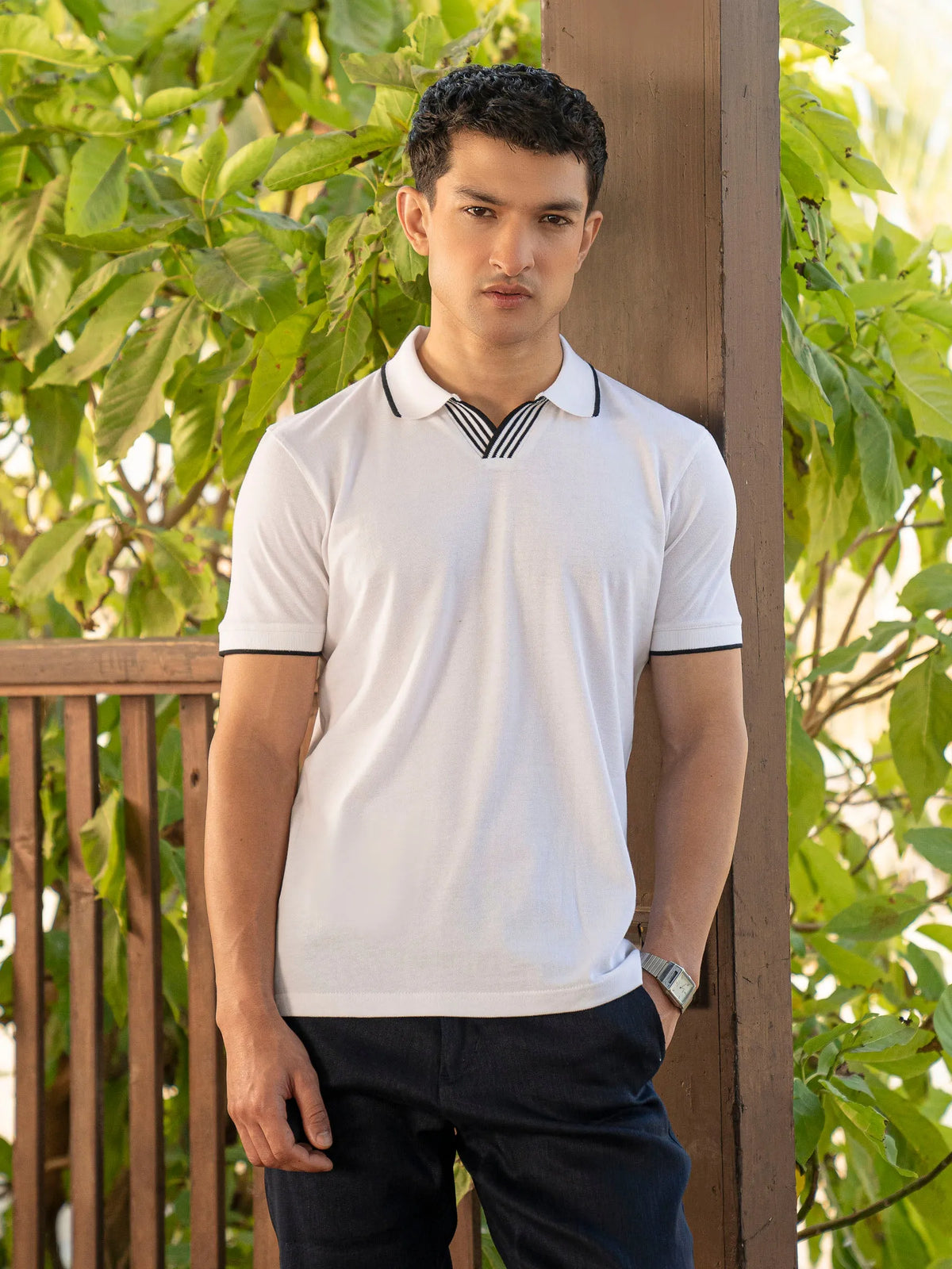 White cotton polo shirt with black striped contrast collar and sleeve trim