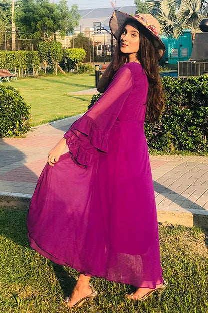 Magenta maxi dress with gathered waist, long flared sleeves, and layered tiered skirt