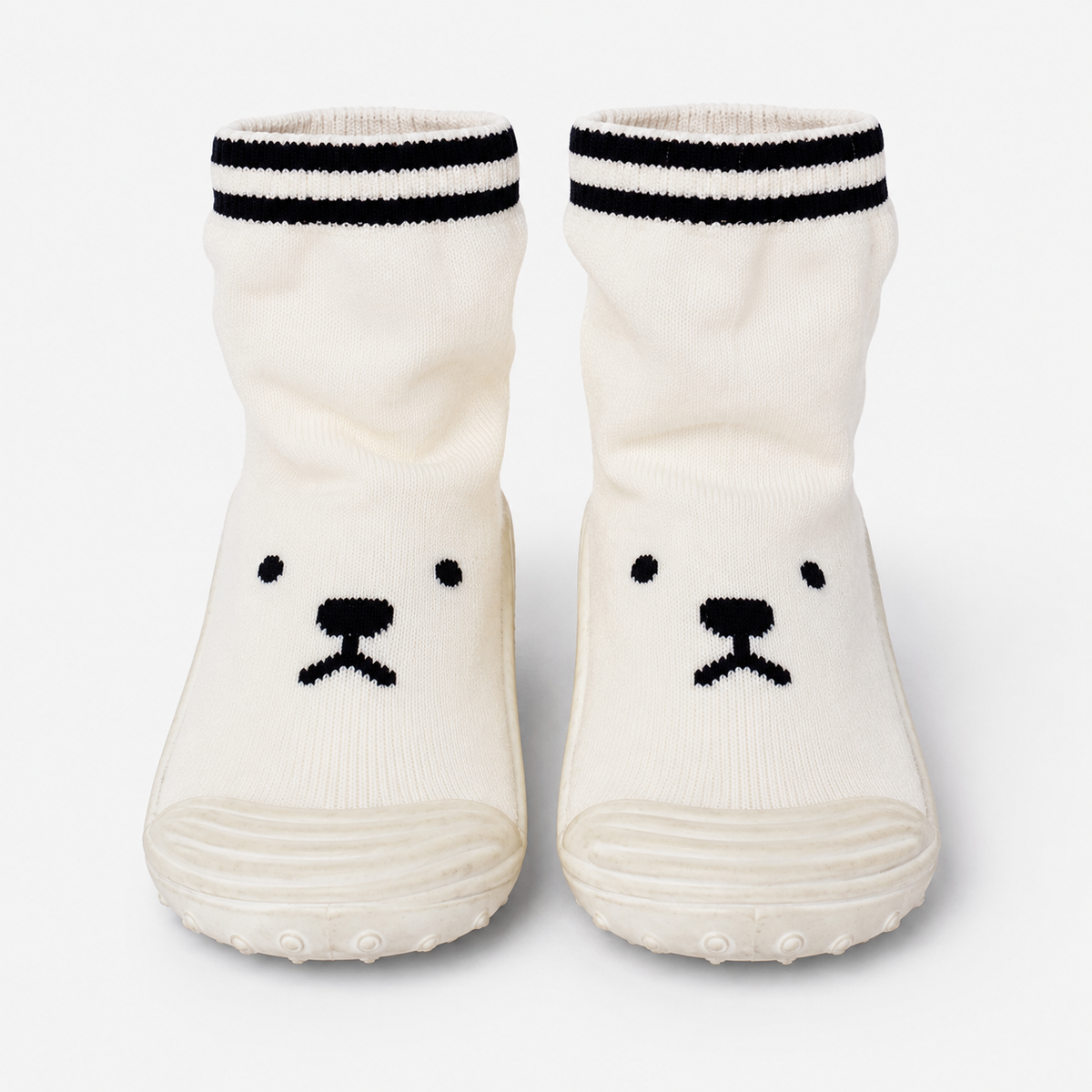 White knit baby socks with black striped cuffs and cute bear face