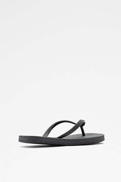 Black flip-flop sandal showing curved thong strap and textured sole
