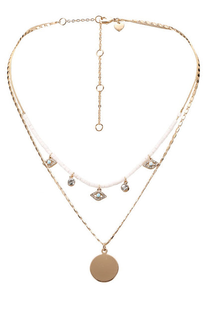 Gold-tone beaded necklace with white cord and round disc pendant, crystal drops