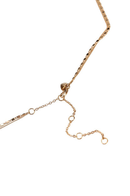 Gold-tone beaded necklace clasp and chain with crystal-studded links, close-up