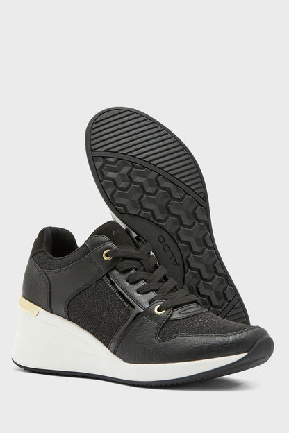 Black low-top sneakers with textured tread sole and knit side panels