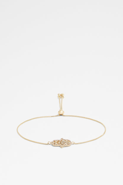 Gold charm bracelet with star-like centerpiece and dangling clasp