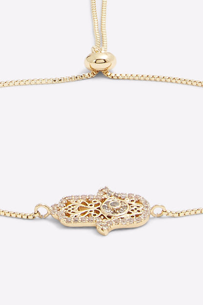Gold chain bracelet with oval filigree charm and adjustable clasp links