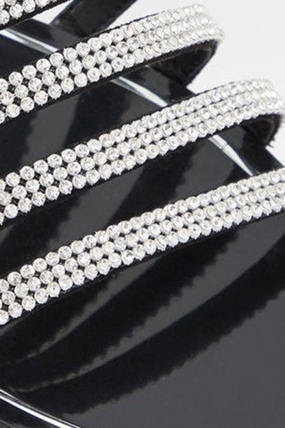Close-up of black sandal strap with multiple rows of clear rhinestones