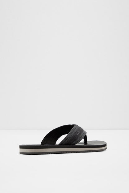 Black slide sandal with single wide thong strap and dark rubber footbed