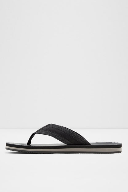 Black thong-style slide sandal with single wide strap and striped sole trim