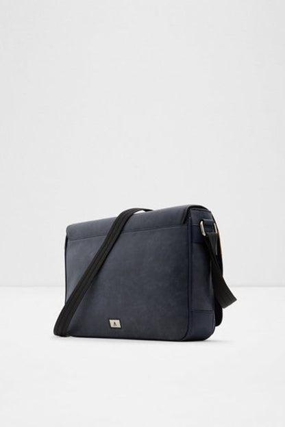 Navy crossbody bag with flap front, metal logo plate, and adjustable shoulder strap