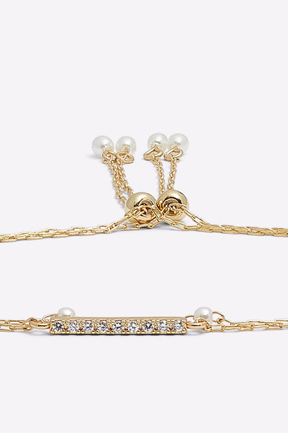 ALDO gold-tone bracelet clasp detail with crystal bar and round bead charms