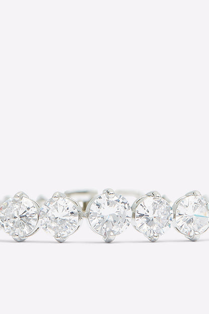 Silver tennis bracelet with a larger center clear stone and surrounding round stones