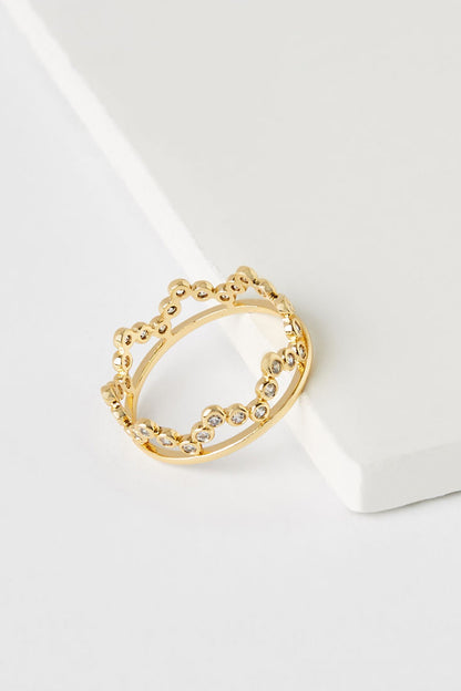 Gold-tone ring with scalloped top and clear rhinestones around band