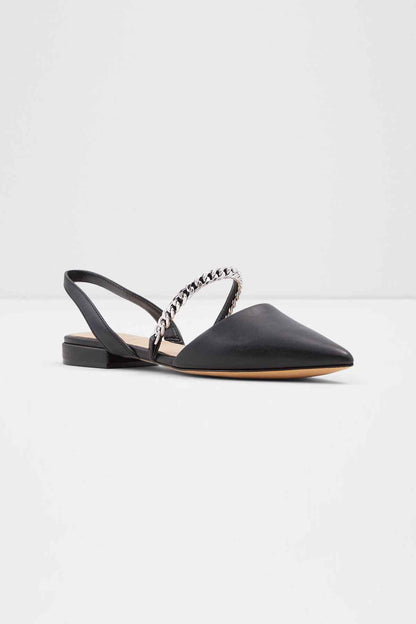 Black slingback flats with chain ornament strap and low block heel, side view