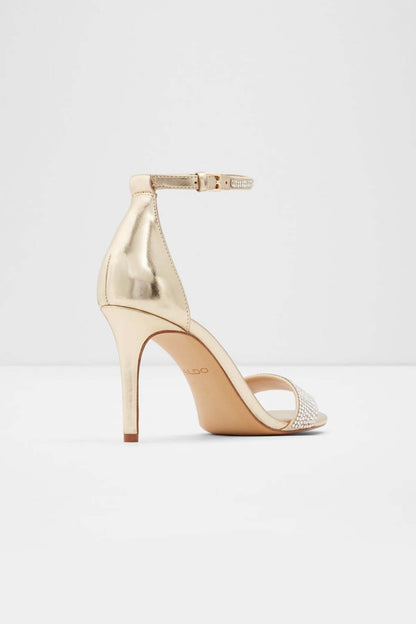 Gold heeled sandal with rhinestone toe band and ankle strap, open back, stiletto heel.