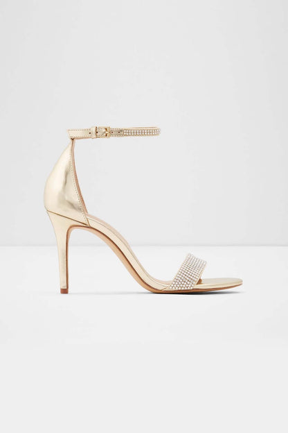 Gold heeled sandal with ankle strap and rhinestone toe strap, stiletto heel.