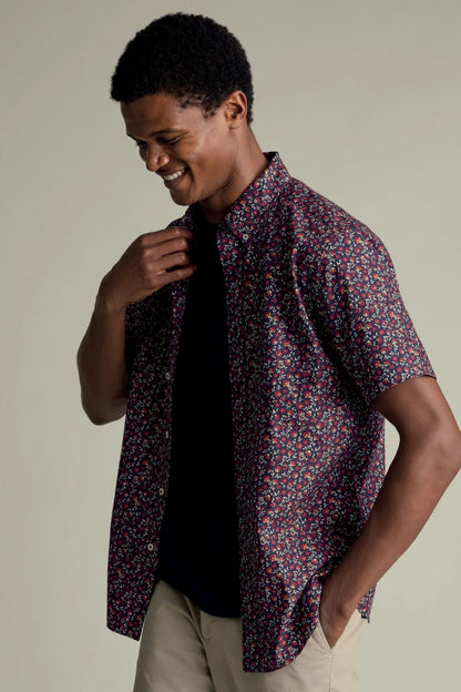 Red and navy floral short-sleeve button-up shirt worn open at the front