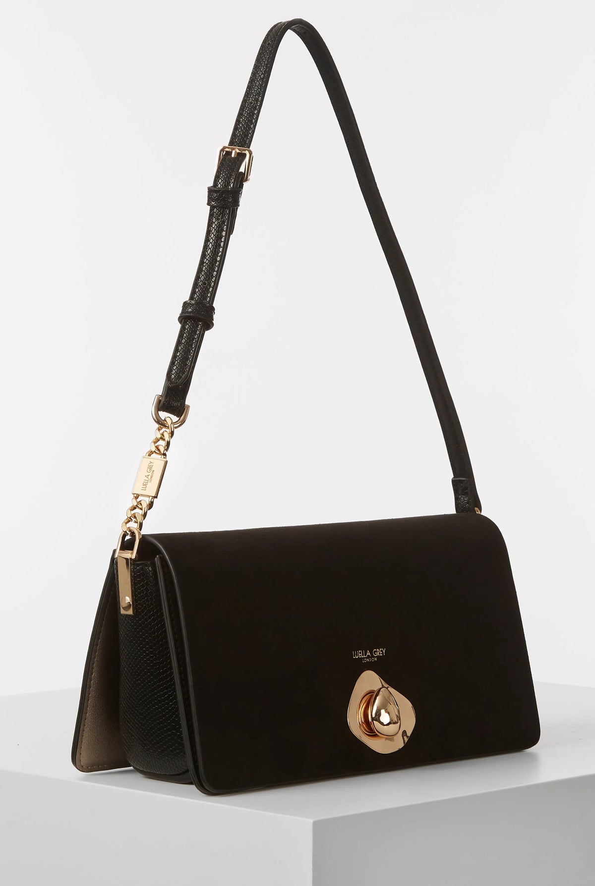 Black shoulder bag with gold emblem front and chain-trim shoulder strap