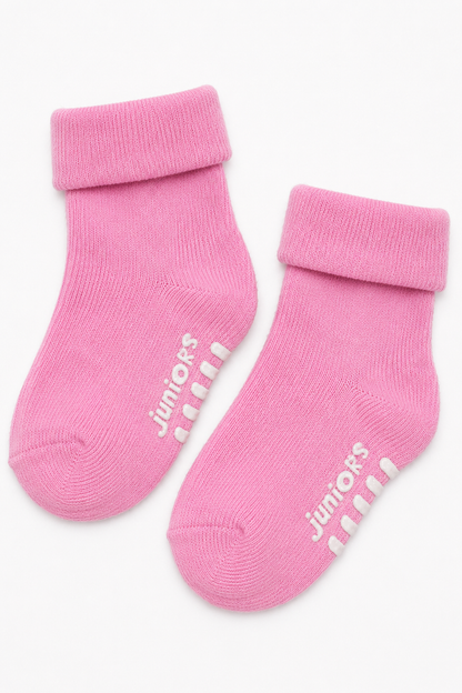 Pink knit baby socks with "juniors" text and ribbed cuffs