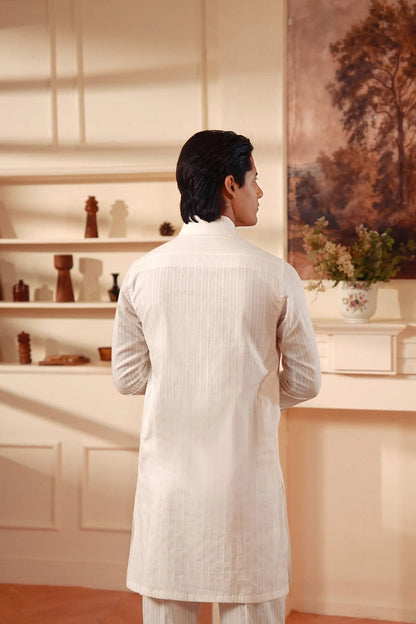 Men's white kurta from back view with full sleeves and curved hem