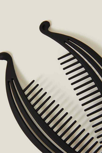 Black curved hair comb close-up with evenly spaced ridged teeth