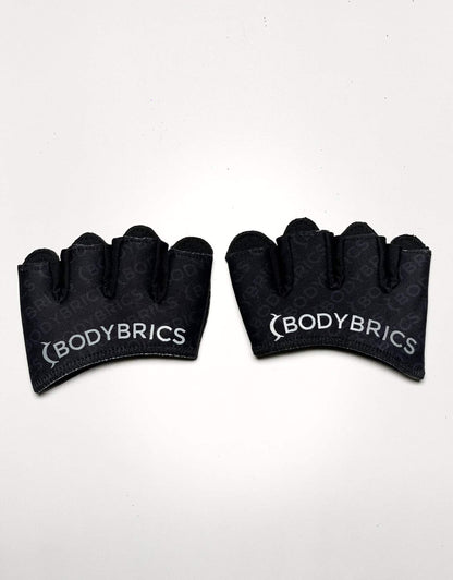 Two black fingerless gloves showing arched cuffs and Bodybrics logo on palms