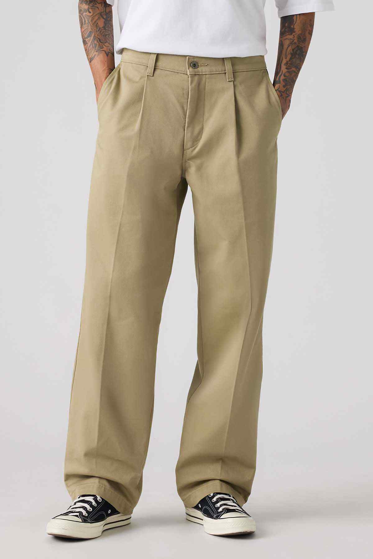 Levi's tan chinos in close-up, front pockets and belt loops with button closure