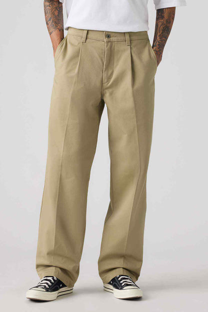 Levi's tan chinos in close-up, front pockets and belt loops with button closure