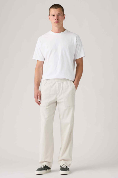 Levi's light beige pants with front pockets, elastic waist, and straight legs