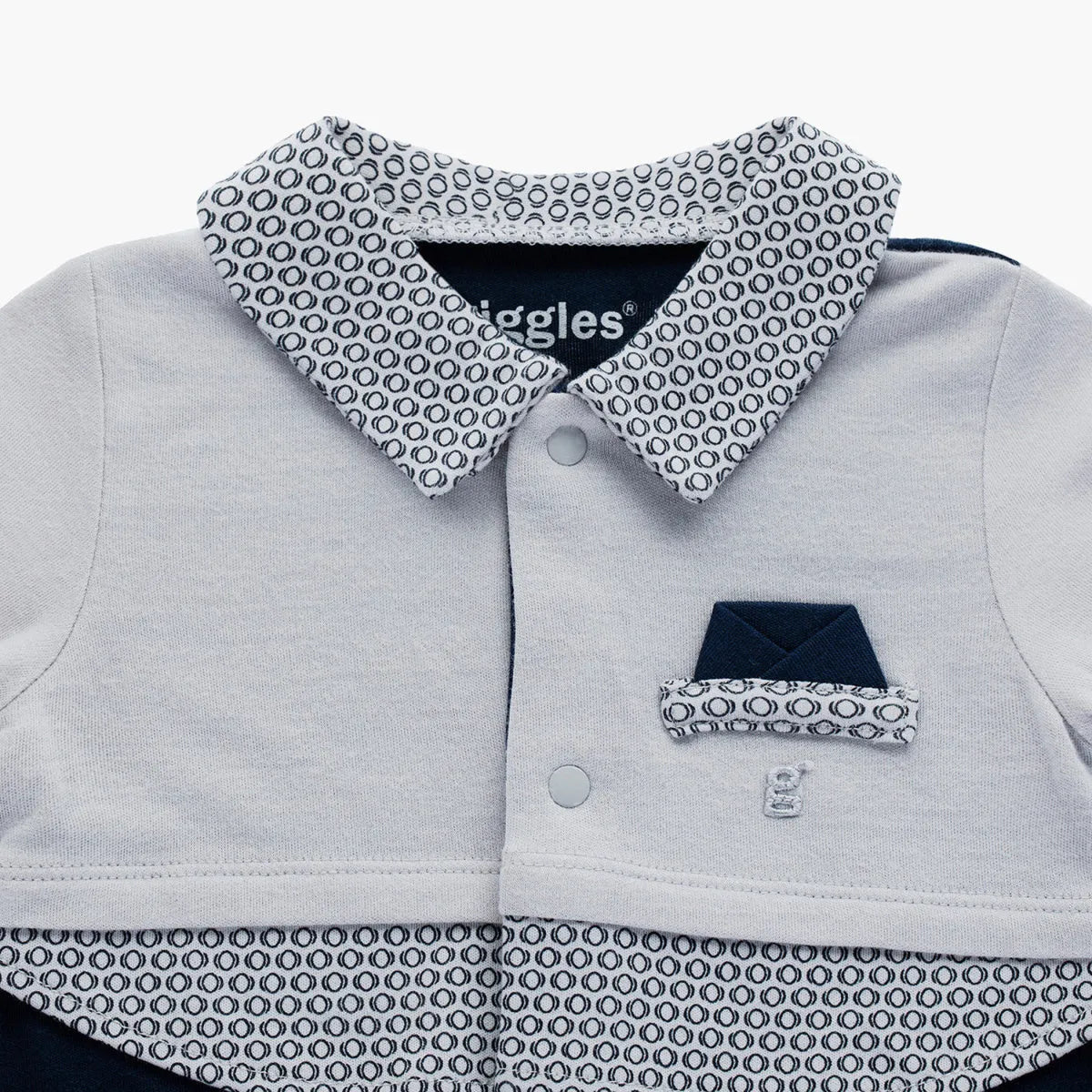 Baby romper close-up: light gray shirt with navy patterned collar and snap buttons
