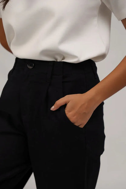 Black cropped trousers waistband detail with button closure