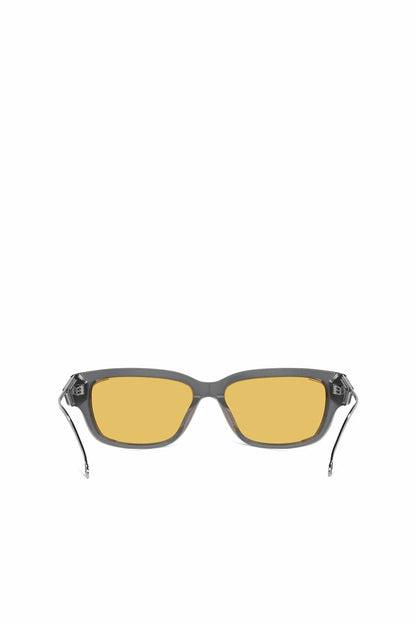Angled sunglasses with dark frame, amber lenses, silver temples and hinges