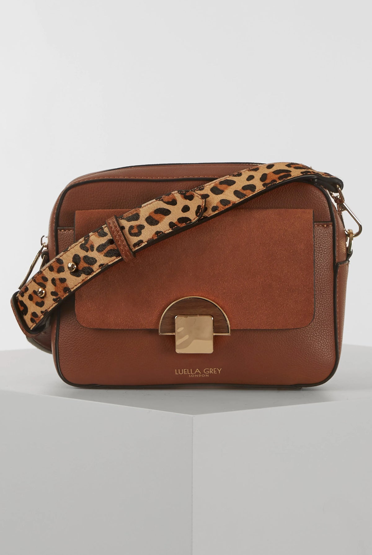 Brown leather crossbody bag with flap and leopard-print strap, silver clasp