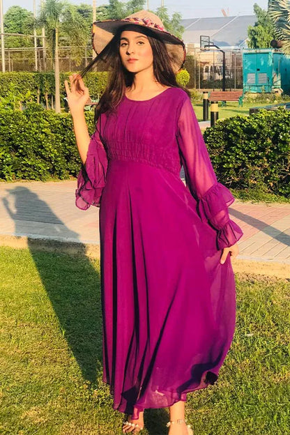 Side view of magenta maxi dress with gathered waist and ruffle-trimmed long sleeves