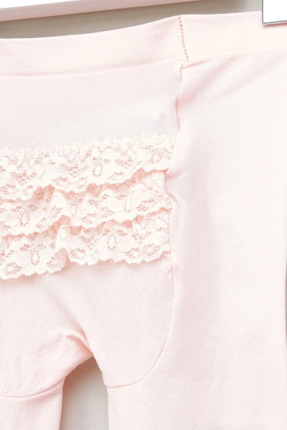 Pink baby tights close-up with lace ruffle trim at thigh