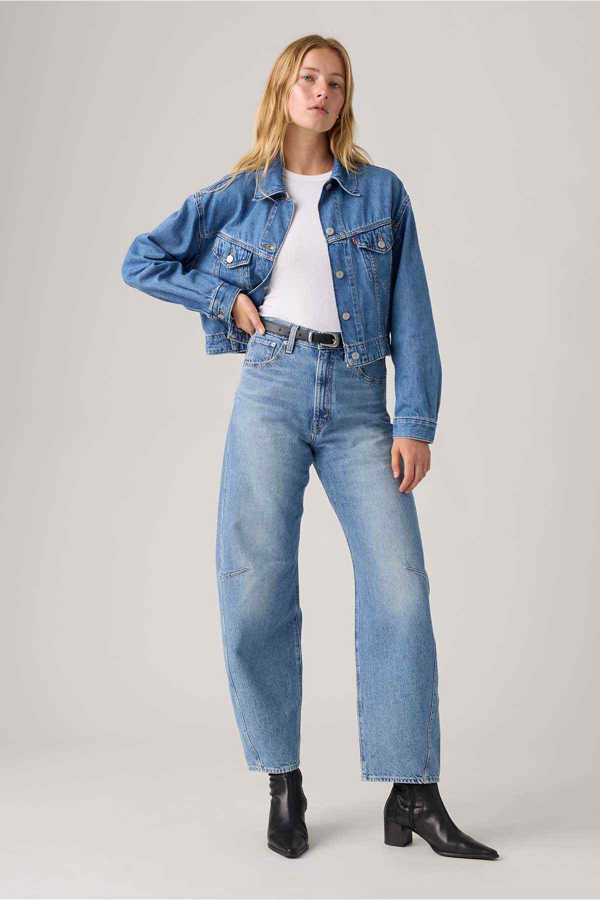 Light-wash denim jeans with wide-leg fit, button fly, and front pockets