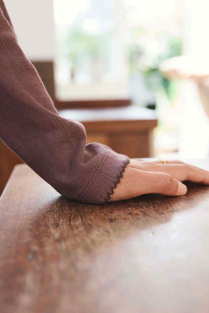 Chocolate brown ribbed sleeve cuff on knit henley top
