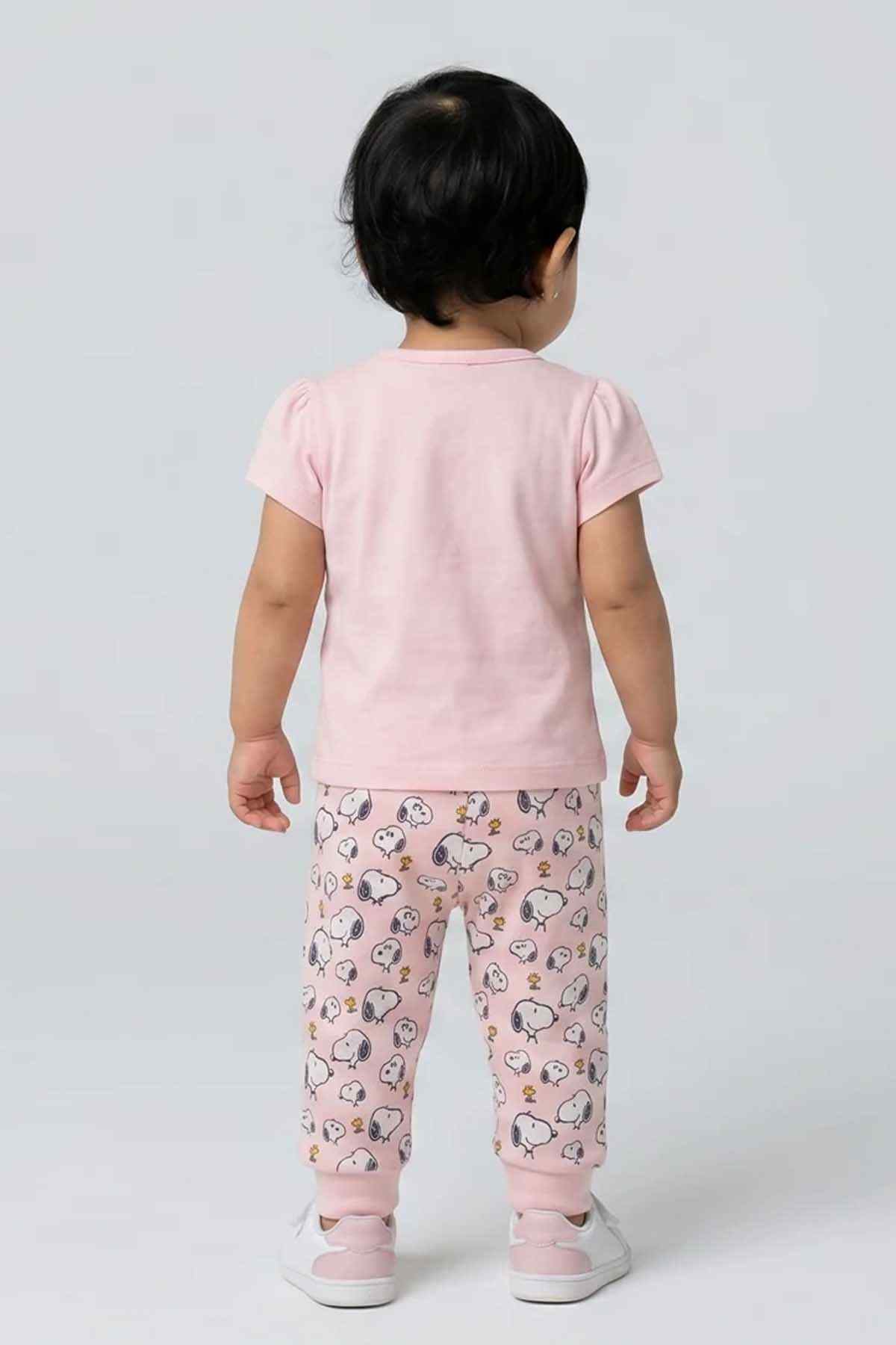 Pink baby pajama set, back view: solid T-shirt with printed pajama pants