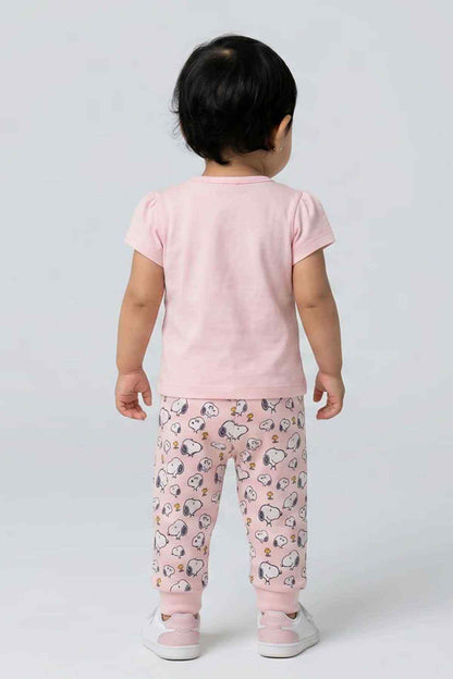 Pink baby pajama set, back view: solid T-shirt with printed pajama pants