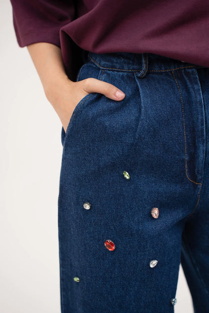Dark blue denim jeans, close-up side pocket with colorful dot details