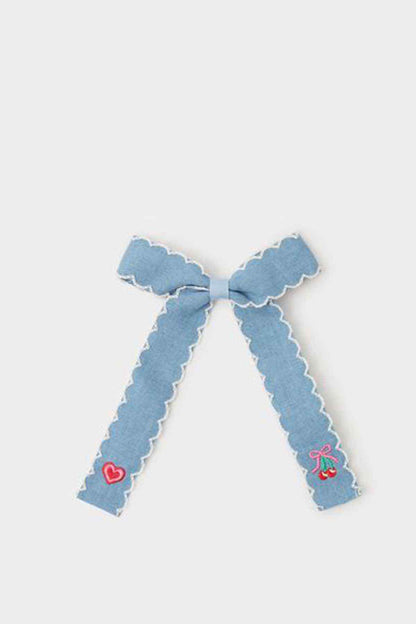 Blue fabric bow with scalloped edges and embroidered hearts